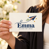 Illustrative size-in-hand view of one 7.5 x 4.5 inch printed vinyl graduation magnet. Emma and 2026 are examples; props not included.