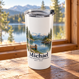 Illustrative cabin window scene of the personalized 20oz stainless steel tumbler. Michael and 2026 are examples; props not included.