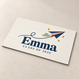 Illustrative front surface and edge detail of one 7.5 x 4.5 inch printed vinyl graduation magnet. Emma and 2026 are examples; props not included.